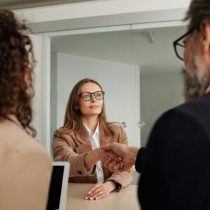 Business professionals shaking hands during a meeting. Ideal for concepts of partnership and collaboration.